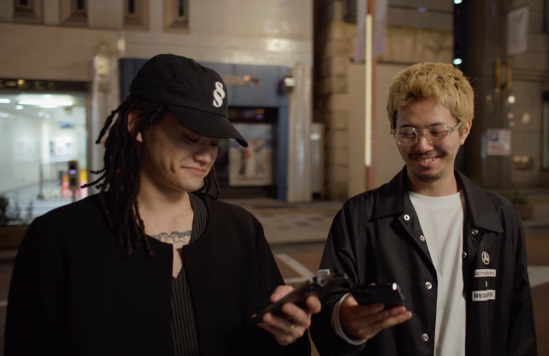 two users on the streets, looking at phones